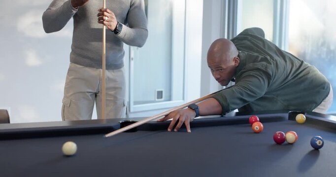 Diverse male friends socializing at home pool table lining shot chalking cue greeting arriving pal