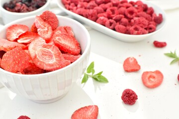 Slices of dried strawberries, raspberries and lingonberries, delicious freeze-dried berries. © Natalia