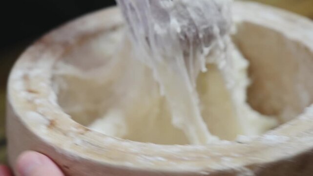 Traditional Mochi Being Pounded in a Wooden Mortar
