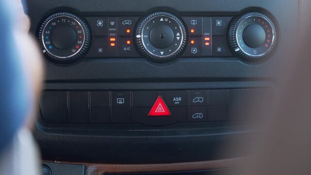 Emergency warning button on the modern dashboard, turning on flashing hazard lights for safety in case of a road problem or emergency