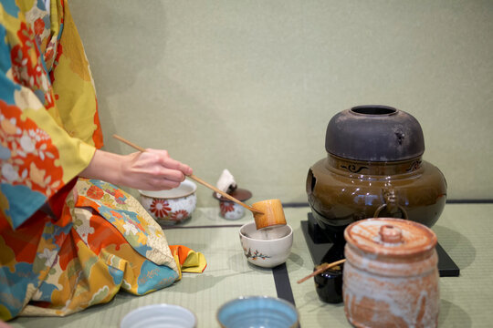 Japanese, hands and matcha for tea ceremony in Chashitsu room with kimono dress and traditional custom. Person, temae and vintage style outfit for culture, fashion and honor with antique crockery
