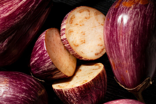 sliced jewel marble eggplant on black background top view