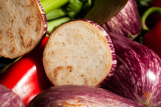 sliced jewel marble eggplant vegetable mix on black background
