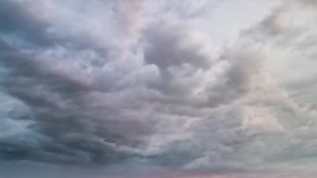 Dramatic dark gray storm clouds rolling across an overcast sky