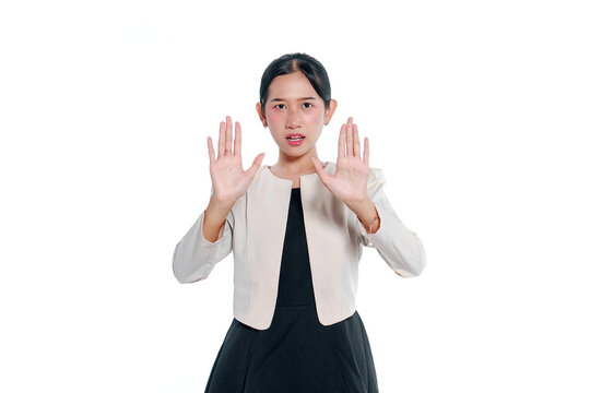 Young Asian Woman Raising Both Hands in a Stop Gesture