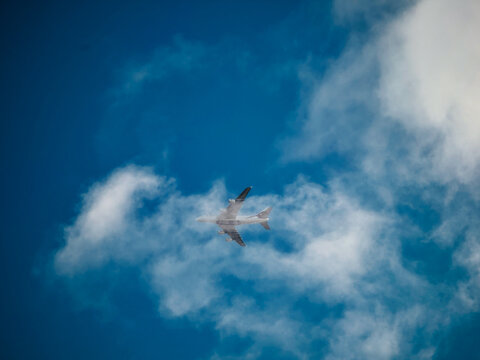 An Emirates Airbus A380 flying through the clouds 