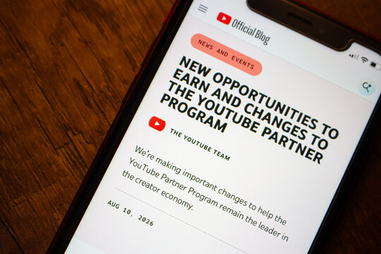 Mexico City, MEXICO - Aug 12 2026 : Close-up of a smartphone showing the YouTube Official Blog post about new earning opportunities and changes to the YouTube Partner Program.