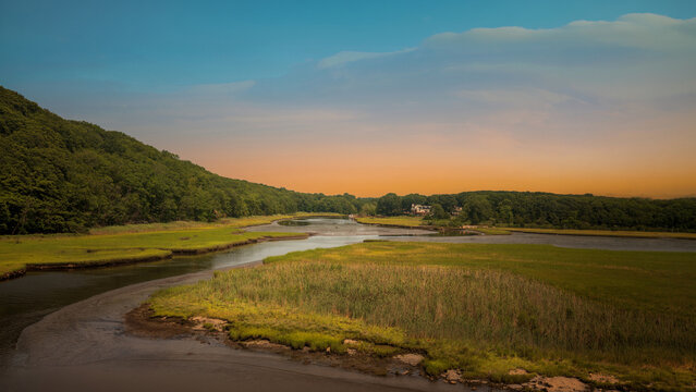 Connecticut marshland landscape on the shore with wild seagrass and curved river at low tide