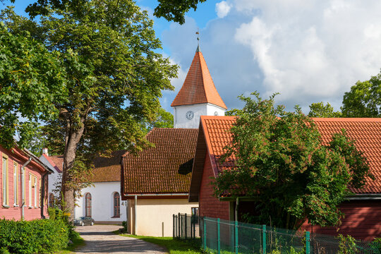 Historic Church Tower and Traditional Wooden Houses in Talsi Latvia on a Sunny Summer Day