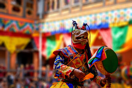 Bhutan, in the village of Bumthang, a monk mask dancer in his colourful costume dances at the festival of Jakar.	