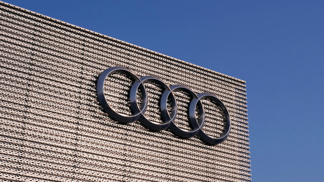 Leicester, England, UK - 17 July 2026: Audi, logo, rings, dealership, facade, emblem, German car showroom exterior on clear blue sky