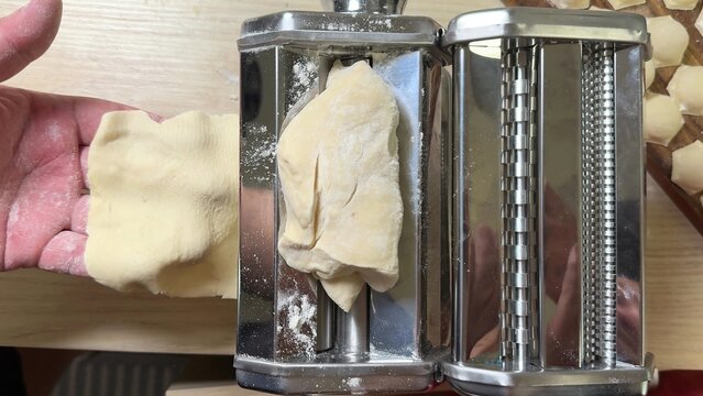 Close up view of a rustic wooden cutting board displaying fresh pale yellow artisan bread dough ready for shaping, perfect for baking preparation shots or culinary arts content