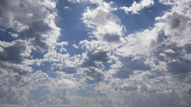 Dramatic cumulus clouds over ocean horizon on a sunny day