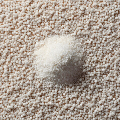 Fototapeta premium White granular fertilizer pile on a background of smaller white pellets, agriculture and plant nutrition