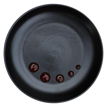 red sauce decoration on black circle plate isolated on white.