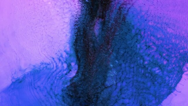 Mixing various colored alcohol inks in a creative art project