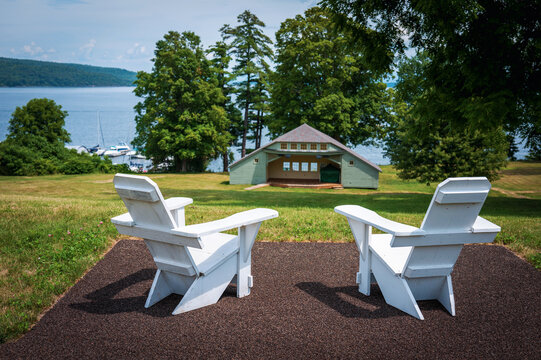 Empty two white wooden benches in the public park