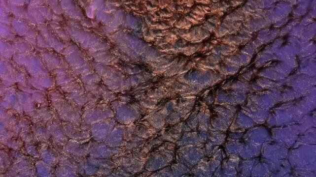 Mixing various colored alcohol inks in close-up view on a surface