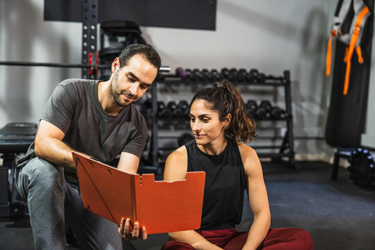 Personal trainer explaining workout plan to female client