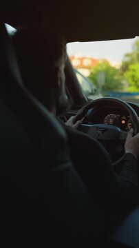 Man driving car through the streets of the city.