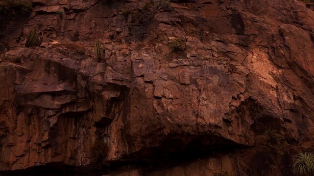 Drone Horizontal Forward Shot Climbing up a Massive Rugged Rock Cliff Face in the Mountains, Chile