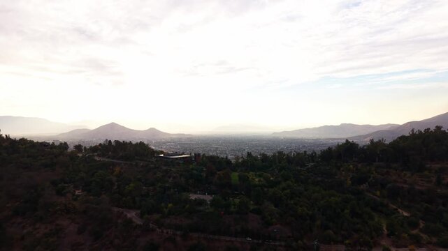 Drone Horizontal Forward Flight Revealing a Vast City Valley from San Cristobal Forest Hill, Chile