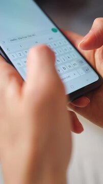 Female hands typing text on smartphone close-up.