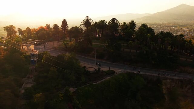 Aerial Horizontal Tracking Shot of San Cristobal Cableway and Mountain Road at Sunset, Chile