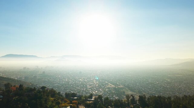 Aerial Horizontal Zooming Out View of a Misty Smog Layer Over Santiago City Valley, Chile