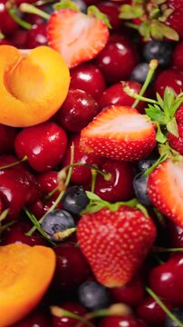 Background of fresh fruits and berries rotating. Vegan sweet food, flat lay.