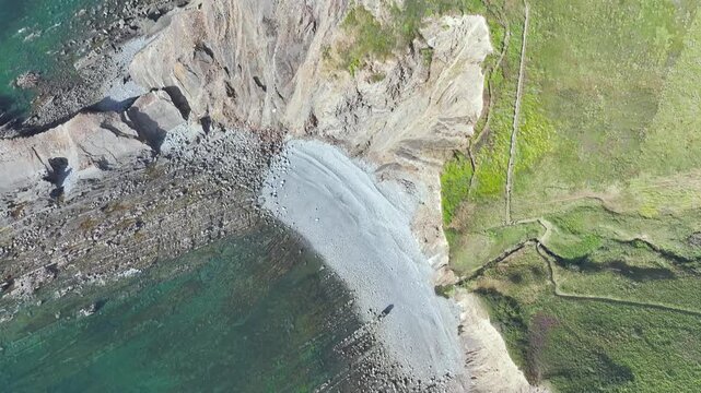 Top Down view of Cliffs and Farms over North Devon and Cornwall Coastpath Border from a drone, Welcombe Mouth Beach, Devon, Cornwall, England, Summer 2026