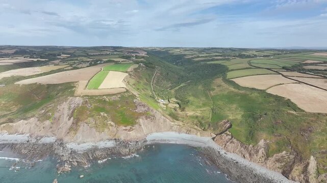 Cliffs and Farms over North Devon and Cornwall Coastpath Border from a drone, Welcombe Mouth Beach, Devon, Cornwall, England, Summer 2026