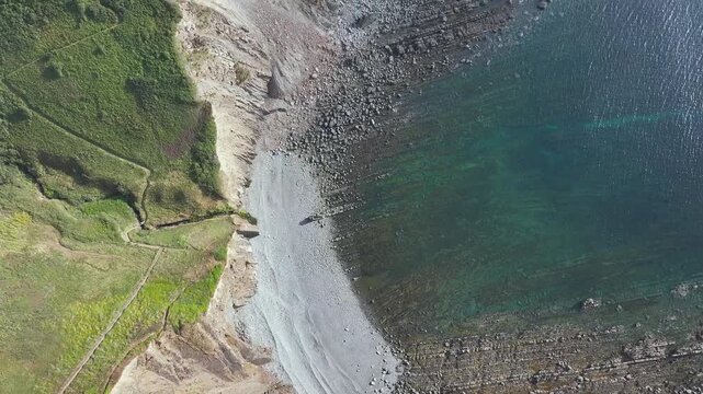 Top Down view of Cliffs and Farms over North Devon and Cornwall Coastpath Border from a drone, Welcombe Mouth Beach, Devon, Cornwall, England, Summer 2026