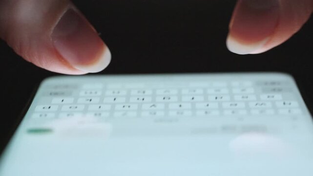 Female hands typing text on smartphone close-up.