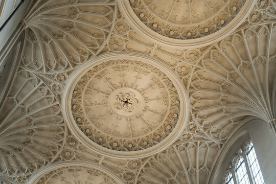 View of the intricate fan vaulting and stone carvings on the ceiling of a historic church in London, England, United Kingdom.