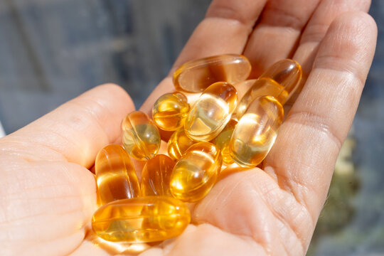 Omega 3 yellow gel capsules, vitamin d bg
