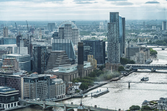 View of the Tate Modern, Millennium Bridge, and the River Thames winding through the modern skyline of London, England, United Kingdom.