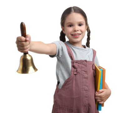 Smiling little girl with books ringing school bell on white background