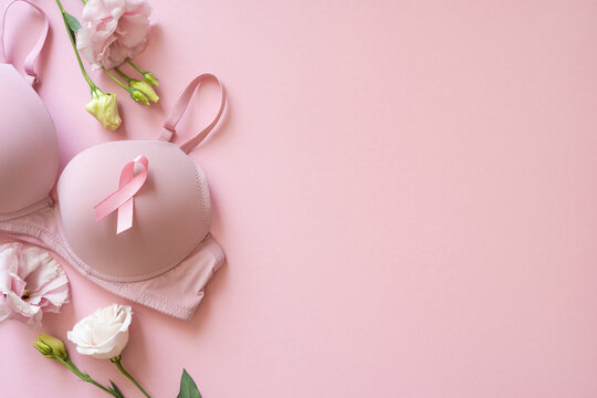 Pink bra with awareness ribbon on soft pink background for Breast Cancer Awareness Month and support campaign