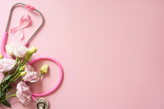 Pink stethoscope, ribbon and flowers on a soft pink background for Breast Cancer Awareness Month