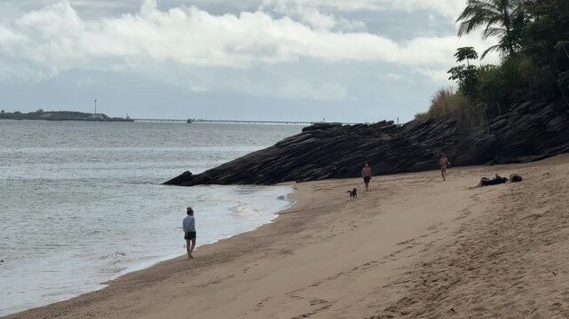 People Enjoying Beach Activities at Feiticeira Beach in Ilhabela, Brazil