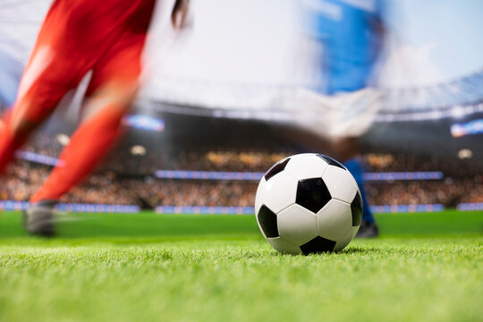 Soccer player shows strong ball control and fast dribbling across the pitch, using agile football footwork to beat an opponent in a one-on-one duel during a dynamic attacking run with motion blur.