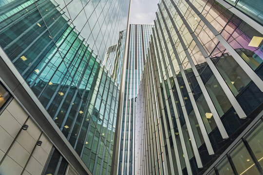 View of modern glass skyscrapers reflecting the sky with geometric architectural lines in the city center London, England, United Kingdom.