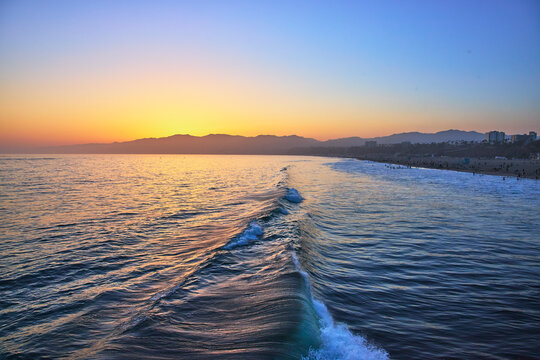 Santa Monica Ocean Waves and Beach at Golden Hour with California Skyline
