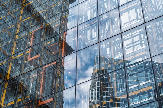 View of the glass facade of the Leadenhall Building reflecting the sky and structural steel beams in London, England, United Kingdom.