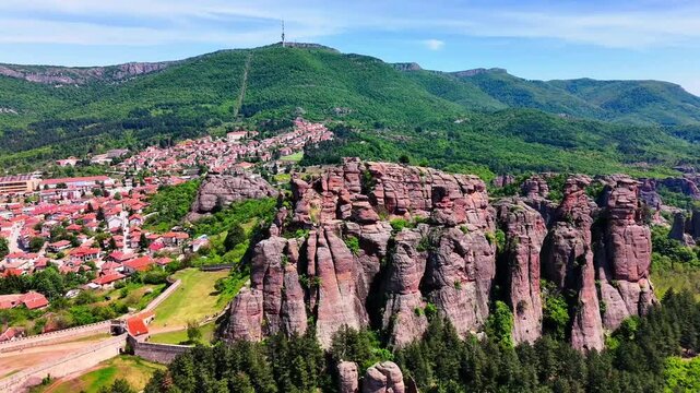 Aerial Drone View of Belogradchik Rock Formations with Town and Mountain Backdrop Bulgaria
