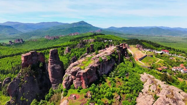 Panoramic Aerial Drone View of Belogradchik Rocky Landscape with Vast Green Mountain Range Bulgaria