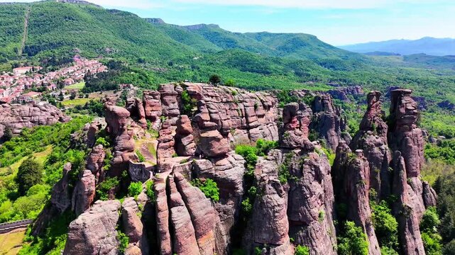 Close Up Aerial Drone View of Dramatic Belogradchik Rock Columns with Town Visible in Bulgaria