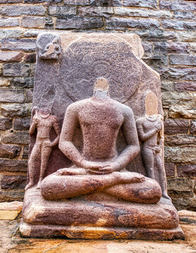 Ancient Seated Buddha Sculpture with Halo at Sanchi Archaeological Site, India