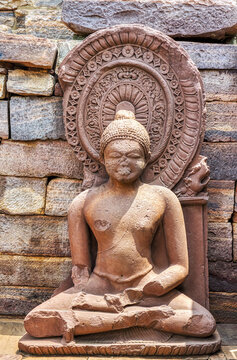 Ancient Seated Buddha Sculpture with Halo at Sanchi Archaeological Site, India